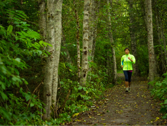 A woman running in a forest